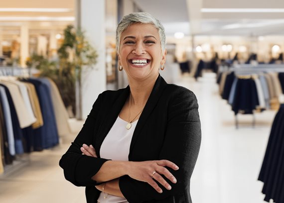 Smiling clothing store worker