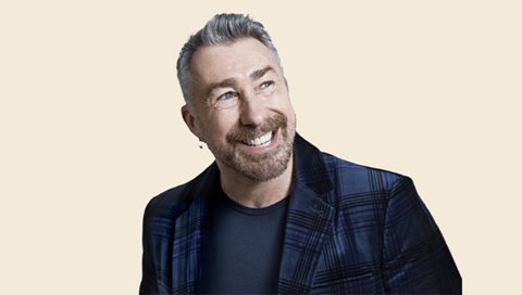 man in blazer smiling