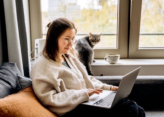 woman sitting on the couch with her laptop