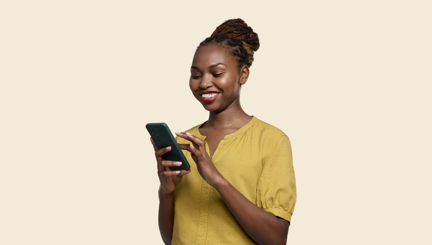 woman in yellow shirt looking at a phone