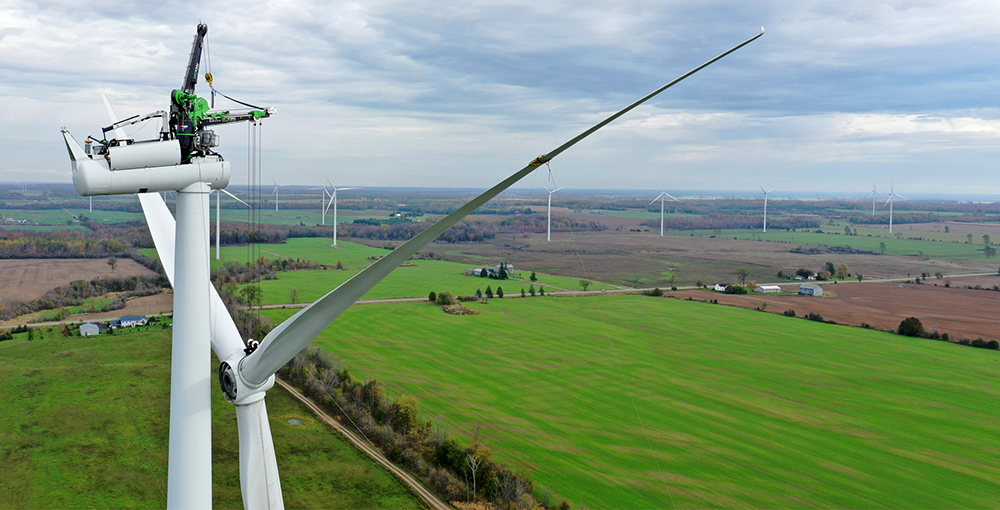 Wind turbine overlooking a green field