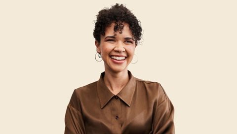 happy woman in brown shirt