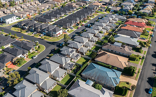 Aerial view of rows of homes in outer suburban Sydney, Australia.