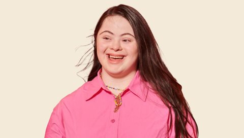 woman smiling in pink shirt