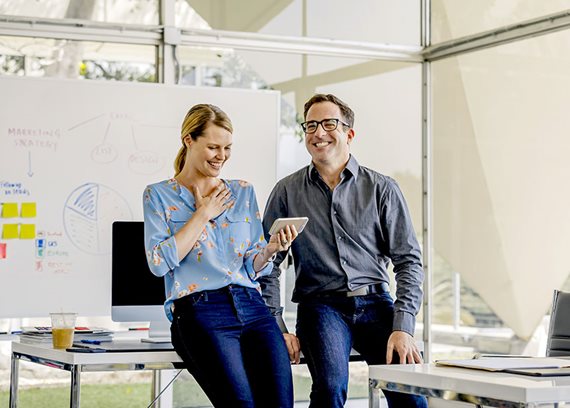 People chatting in front of whiteboard People chatting in front of whiteboard