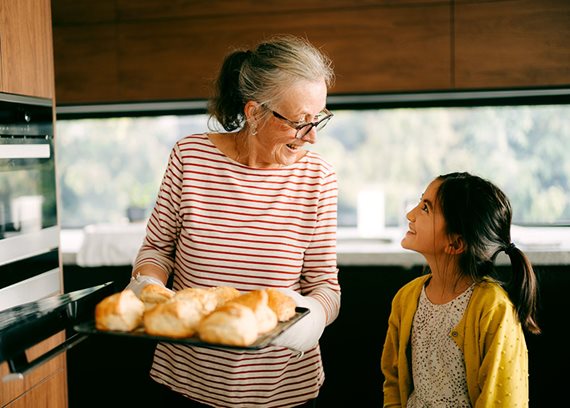 Grandma grandchild baking bread img text