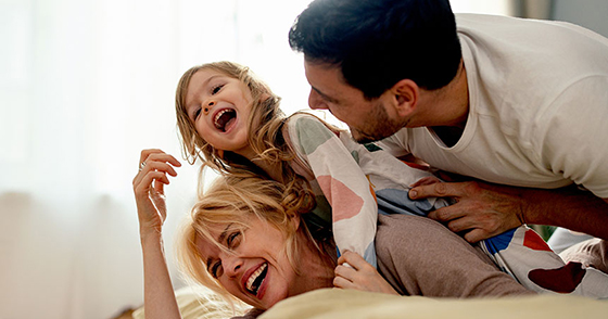 Mother, father and daughter laughing together