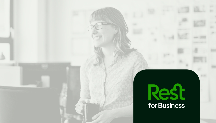 Smiling woman wearing corporate attire and office pass on lanyard